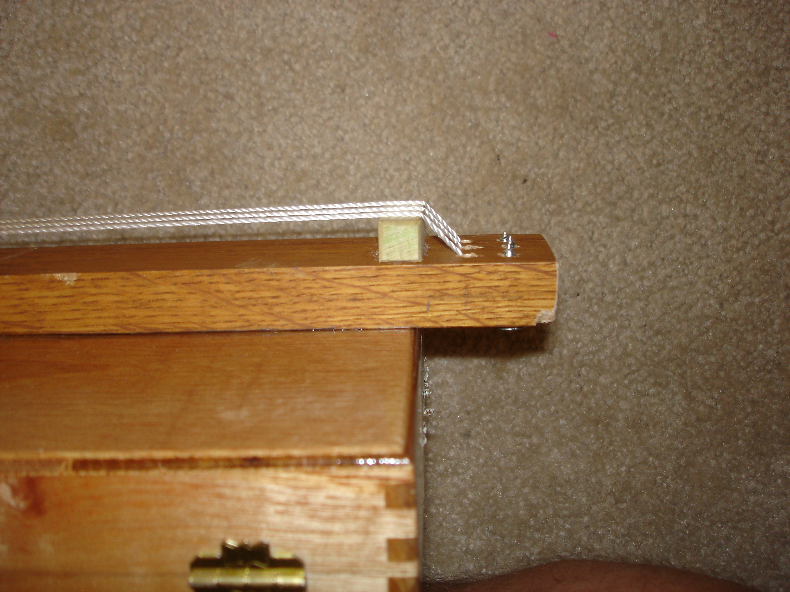 Original bridge with twine for strings. Those screws poking out like that can’t be safe…