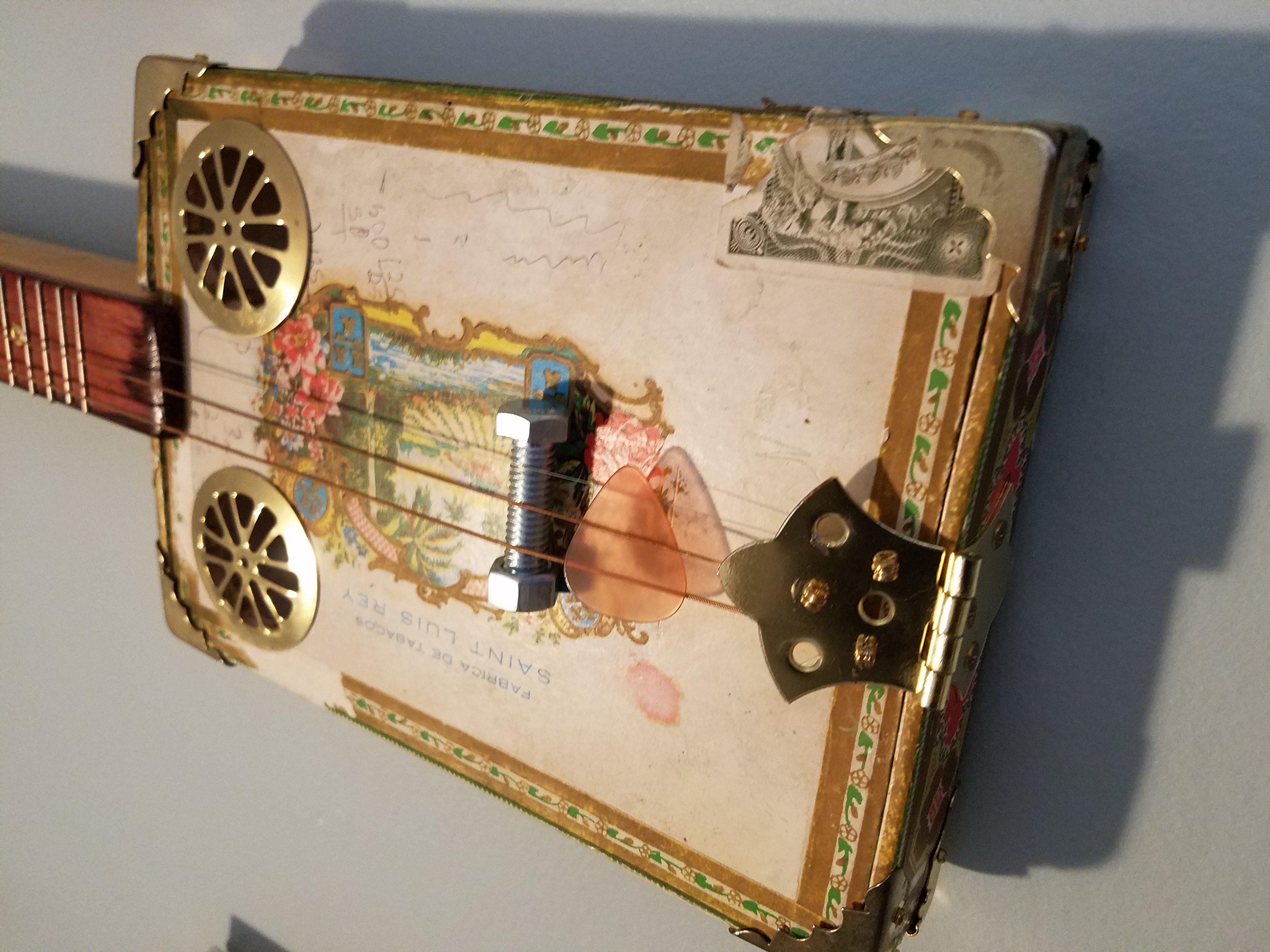 Bolt bridge, and cabinet hinge to hold the strings