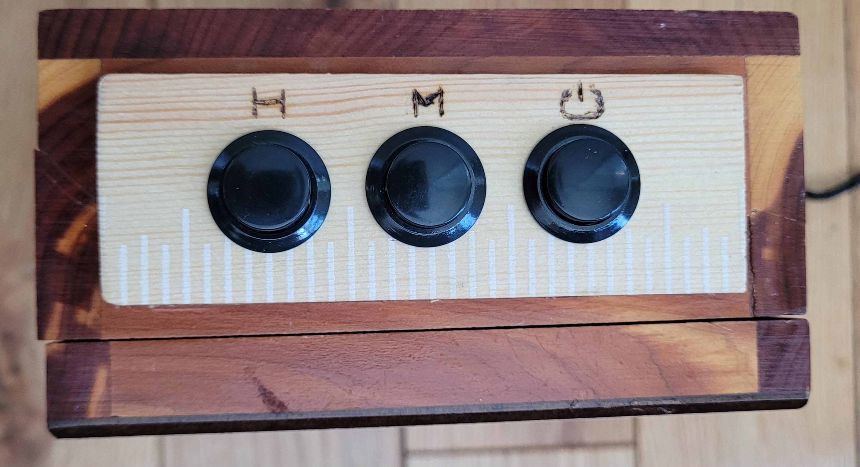 Buttons for adjusting the hours and minutes. The last button turns the LEDs on or off