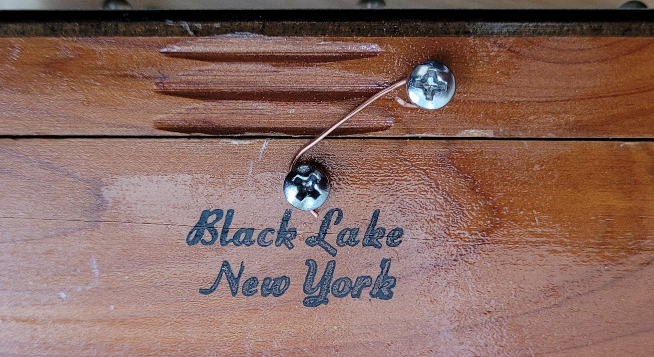 The simplest of latches&mldr;a piece of wire wrapped around two screws