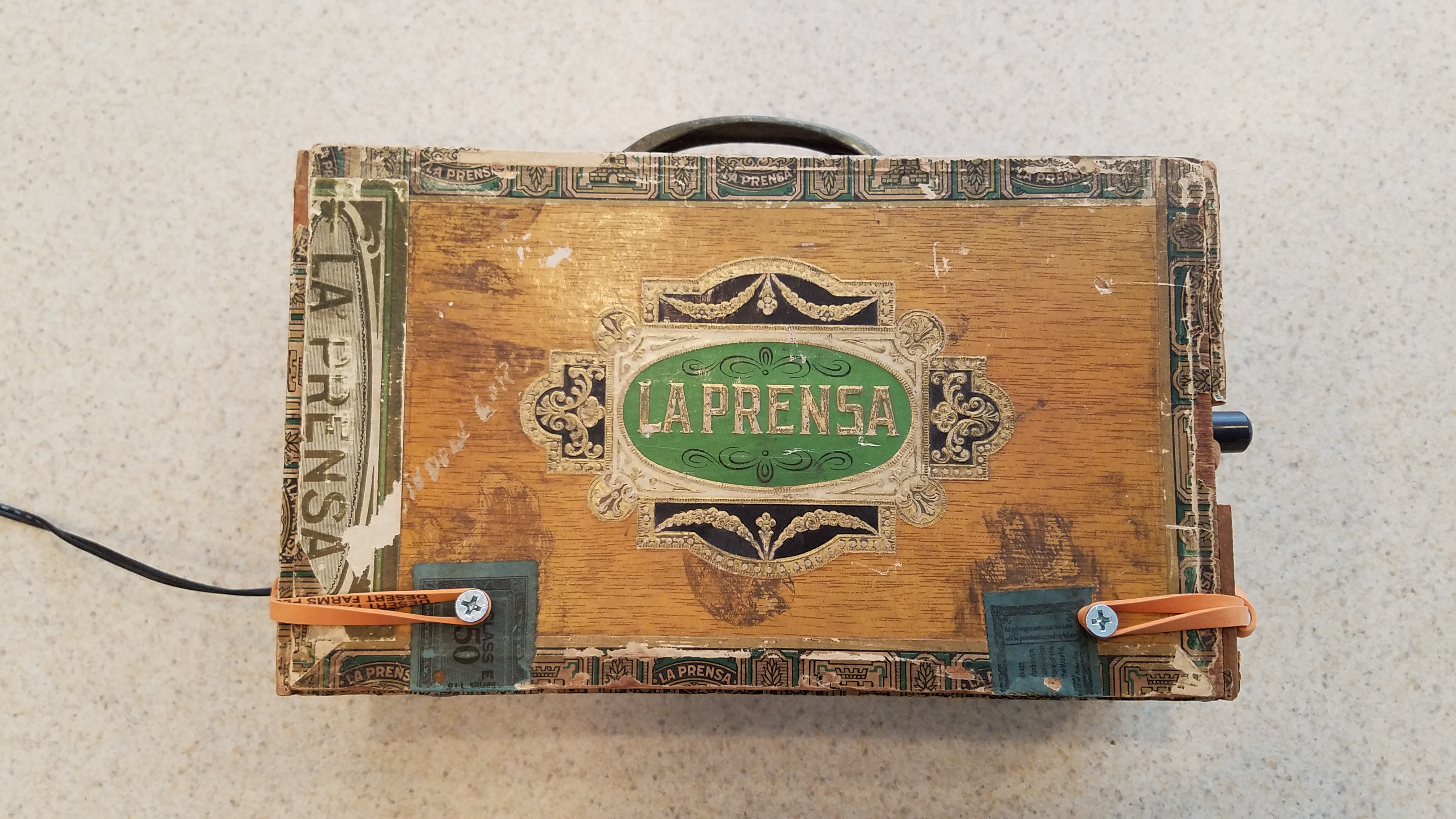 Nothing says quality like using rubber bands to keep the lid shut