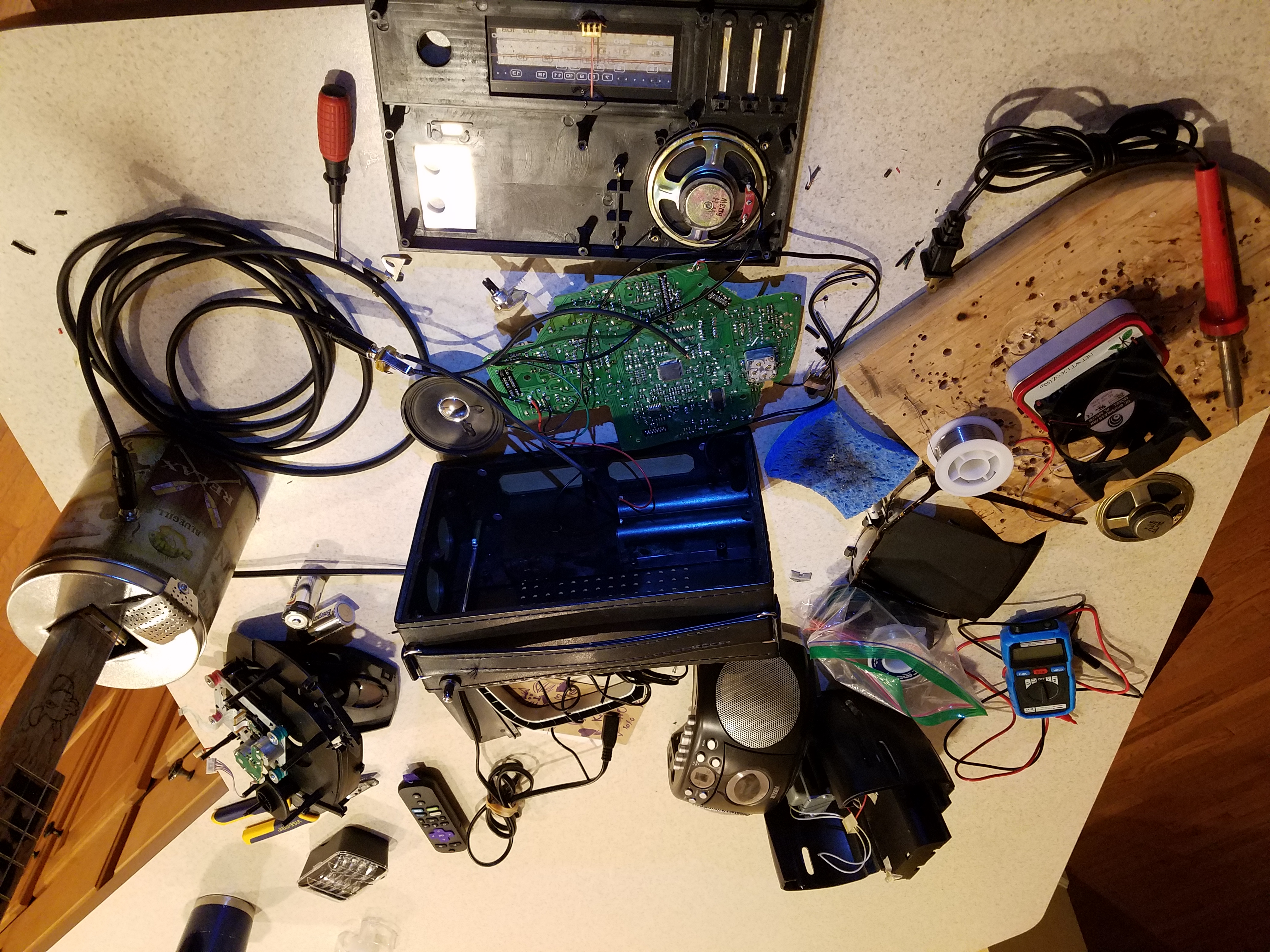 It might not look it, but I know exactly what I am doing in this picture. On the top left is the cassette player that sacrificed itself so that this amp could live. Eagle eyed viewers will see on the bottom left the fume extractor fan I made from an Altoids tin and an old PC fan. On the right is the Popcorn tin chugger I made, featured elsewhere on this website.