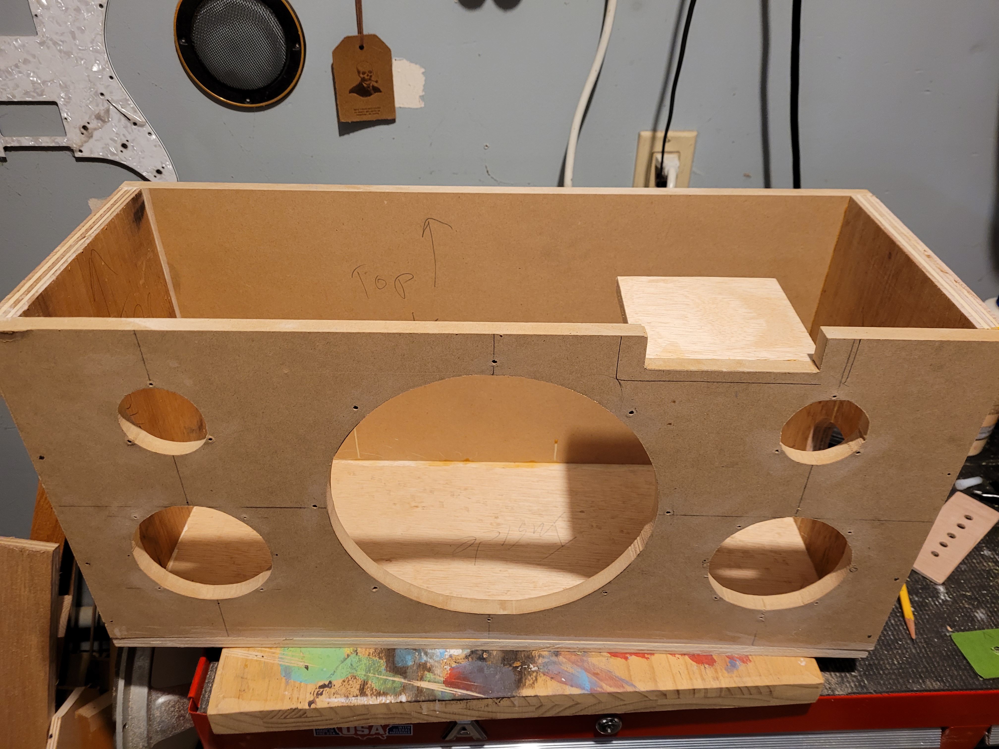 I made a small shelf for the amp to sit in. Once the lid is in screwed on, it holds the amp in place.