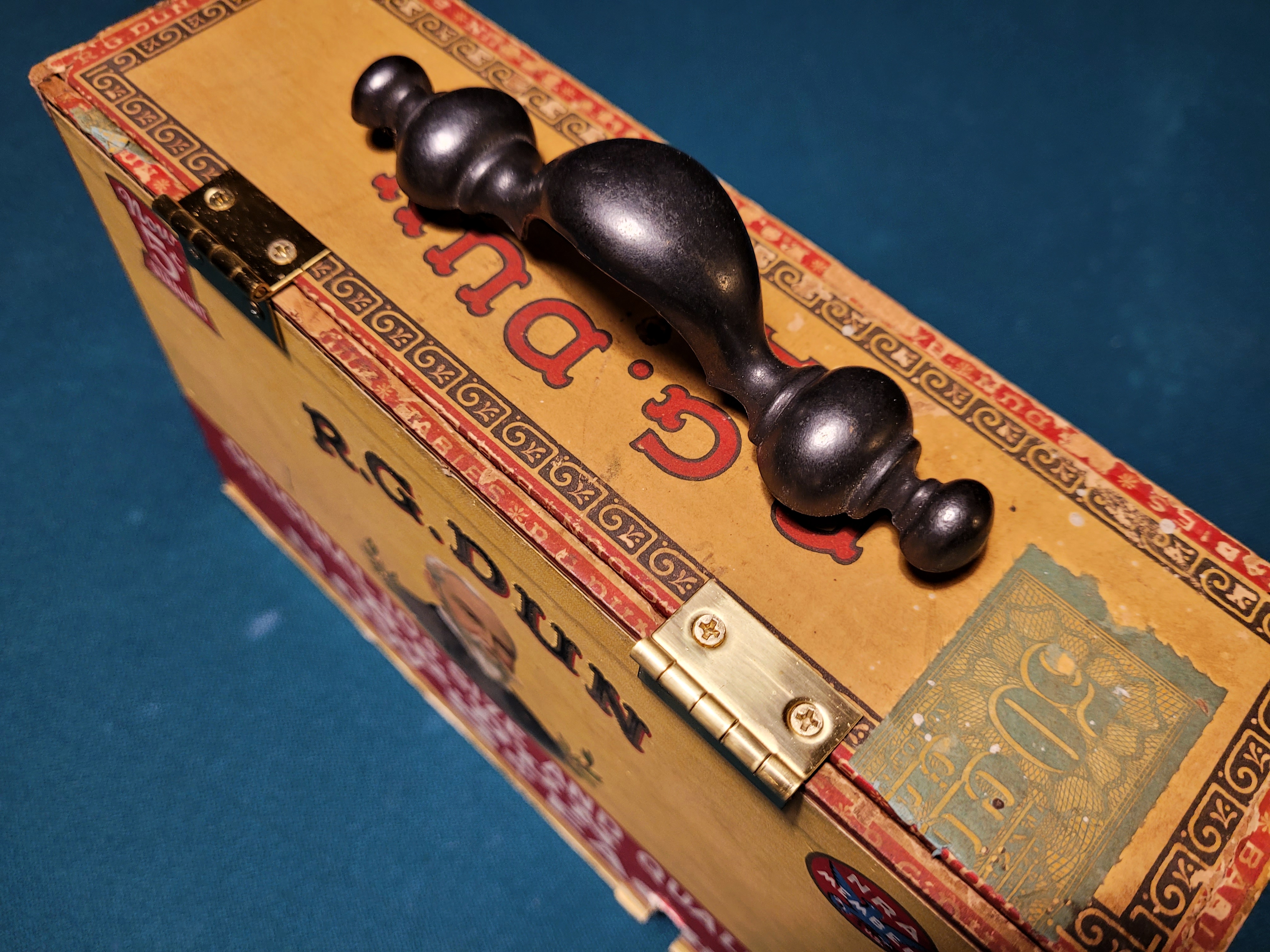 I added this old drawer pull, plus hinges to keep the lid in place. I flipped the lid so you could see the inside lid, which is better looking than the outside