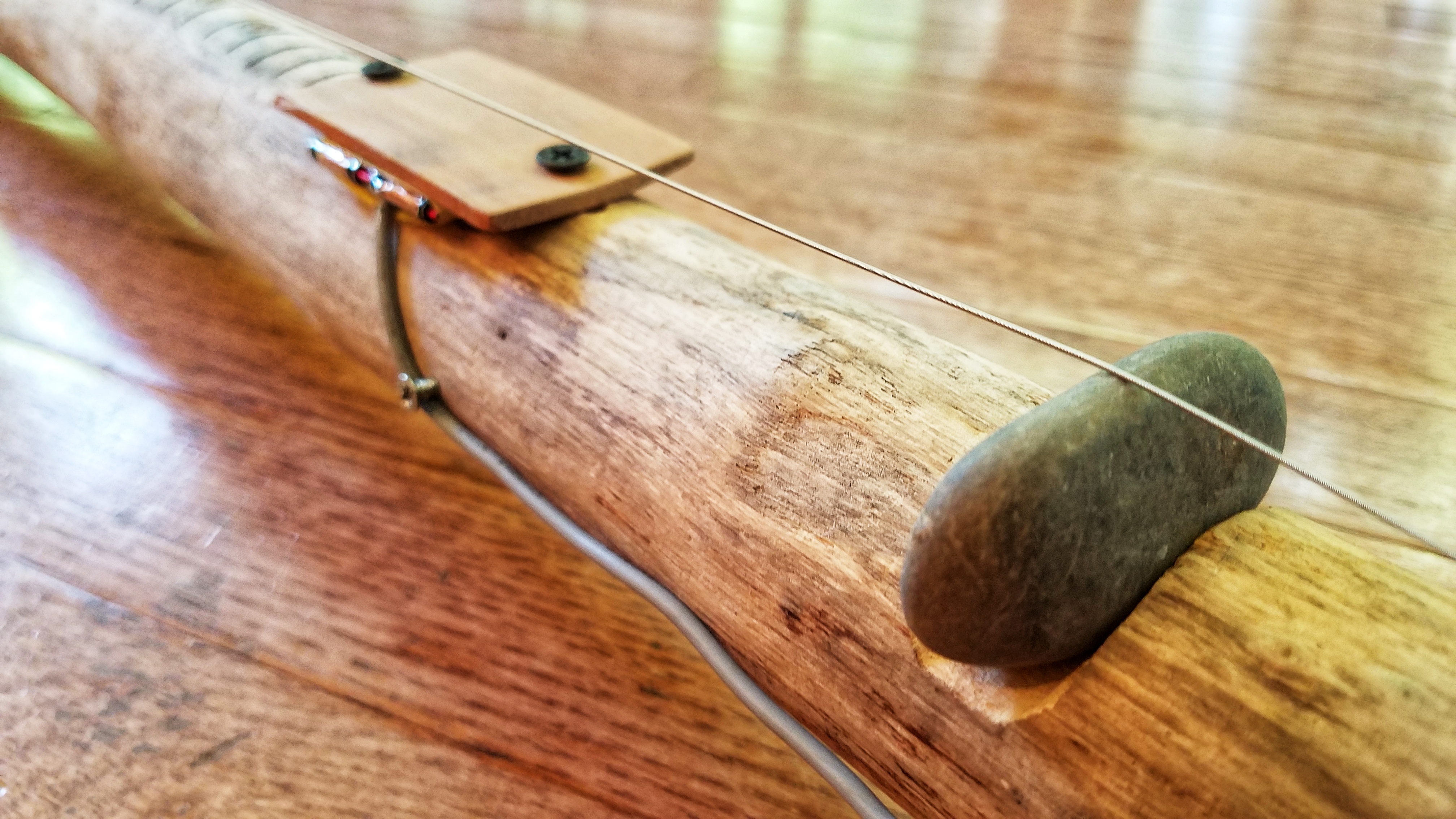 Flat humbucker pickup. The bridge is a rock from the lake