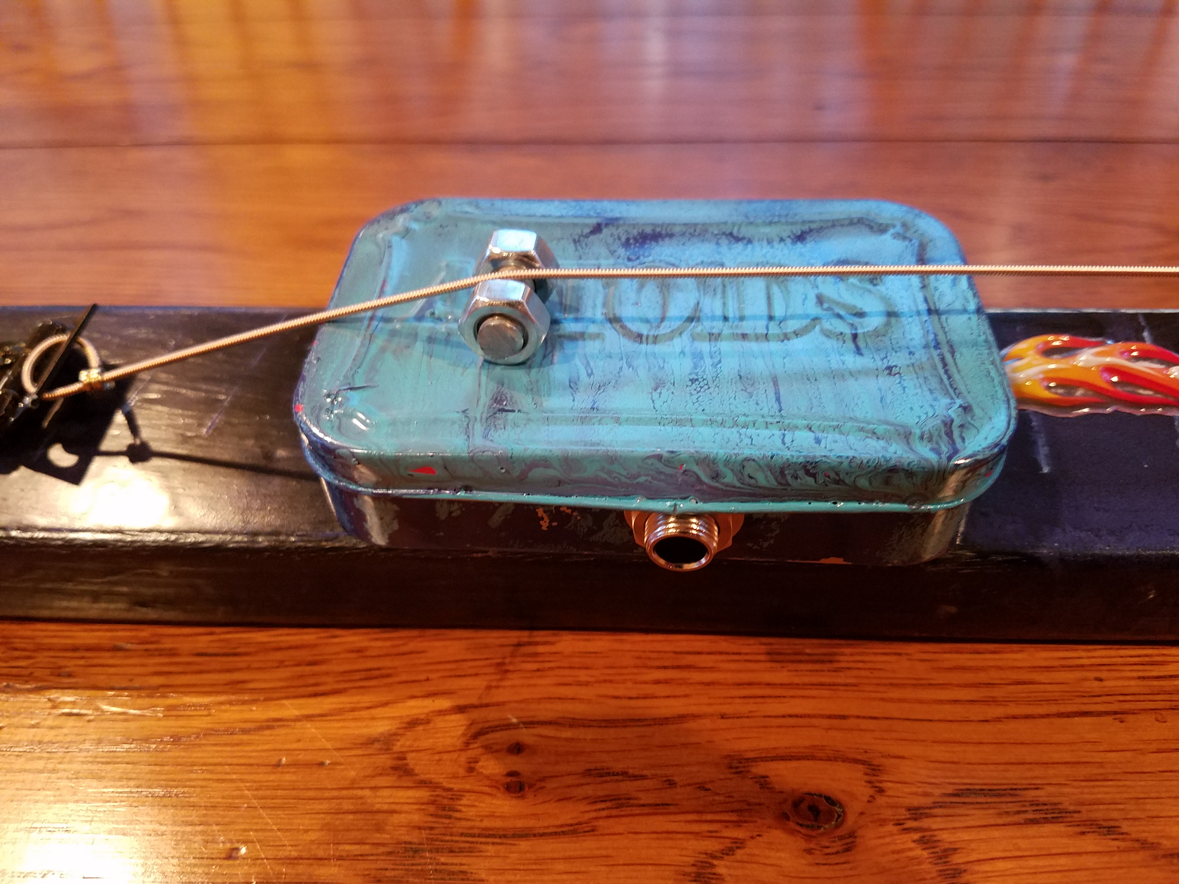 Finished Altoids tin with piezo and bolt for bridge