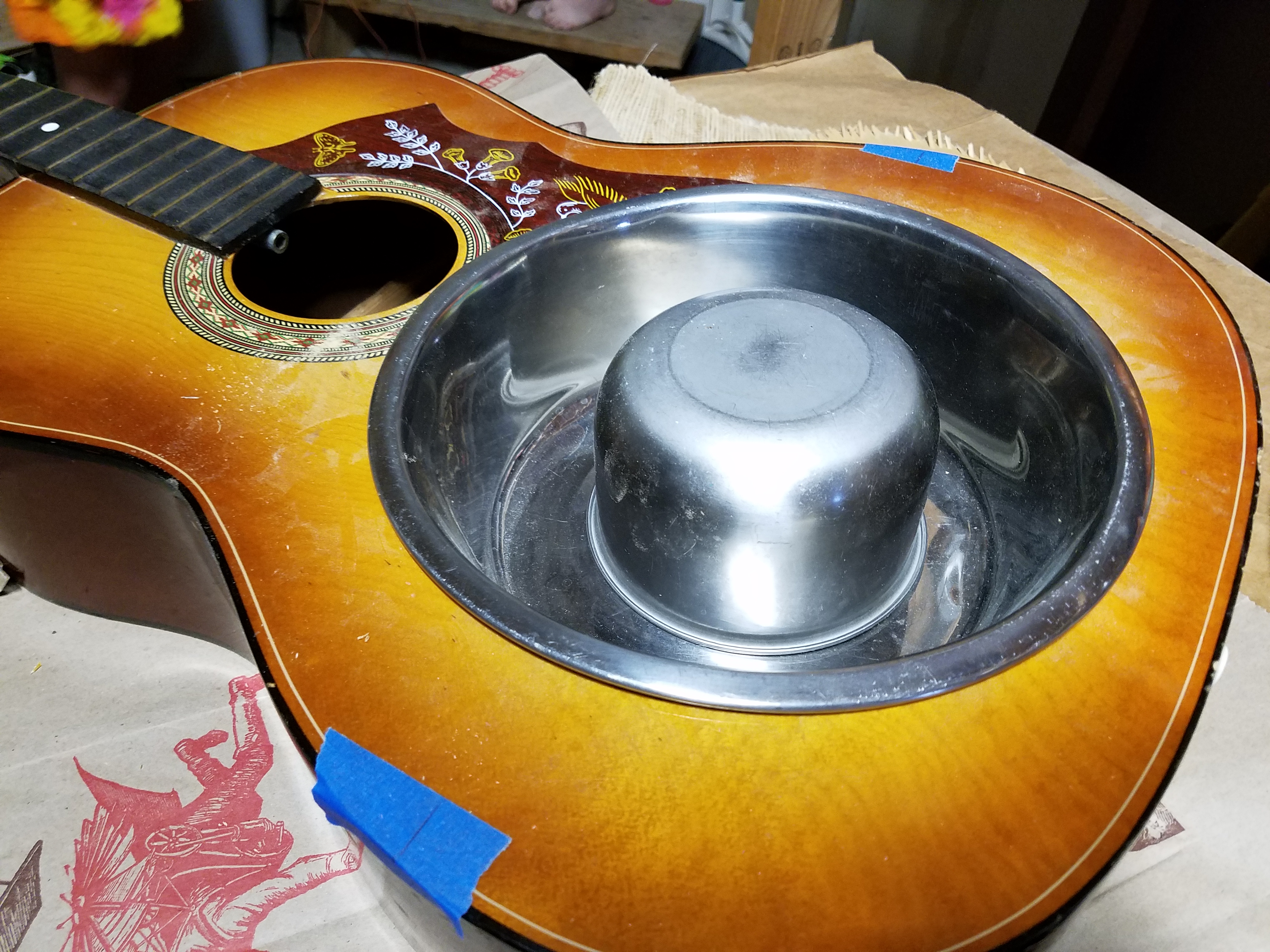 Test fitting the bowls. The blue tape has a line that shows where the bridge goes to keep the same scale length