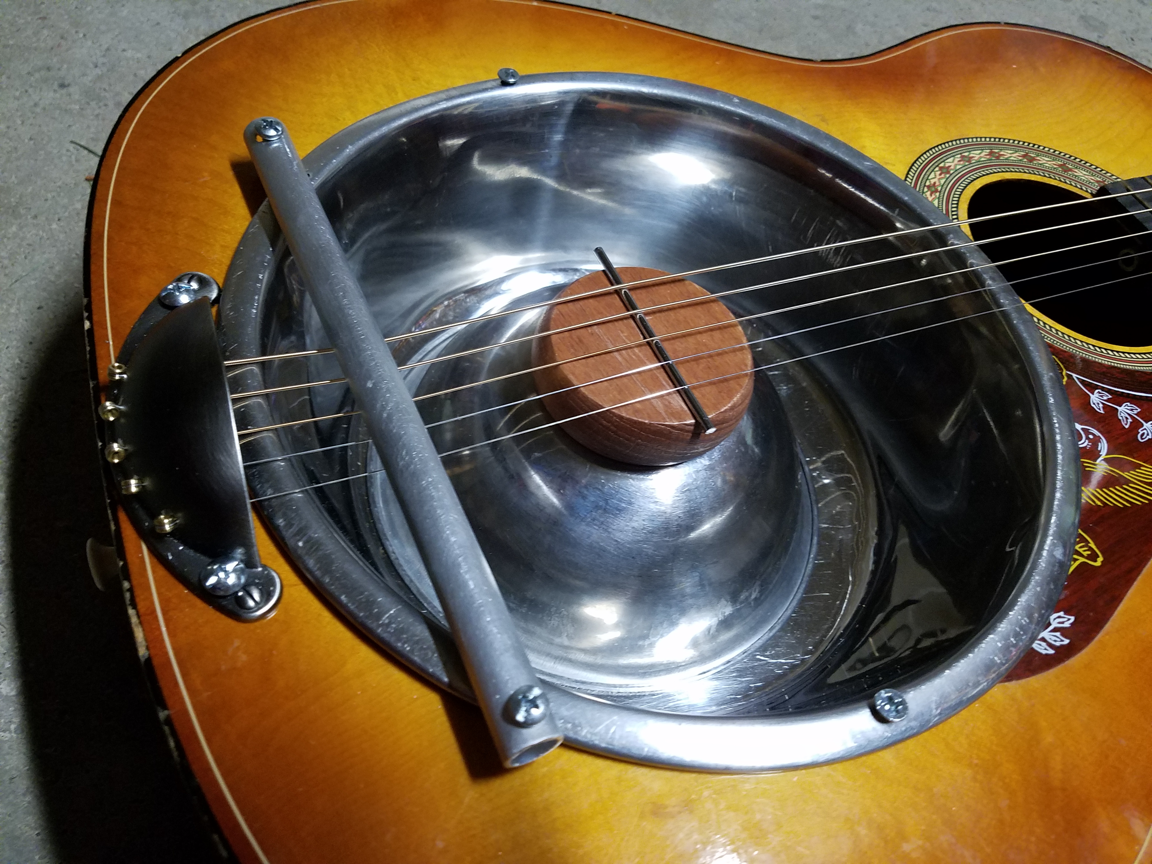 This ugly metal bar is pushing down on the strings so they remain taut