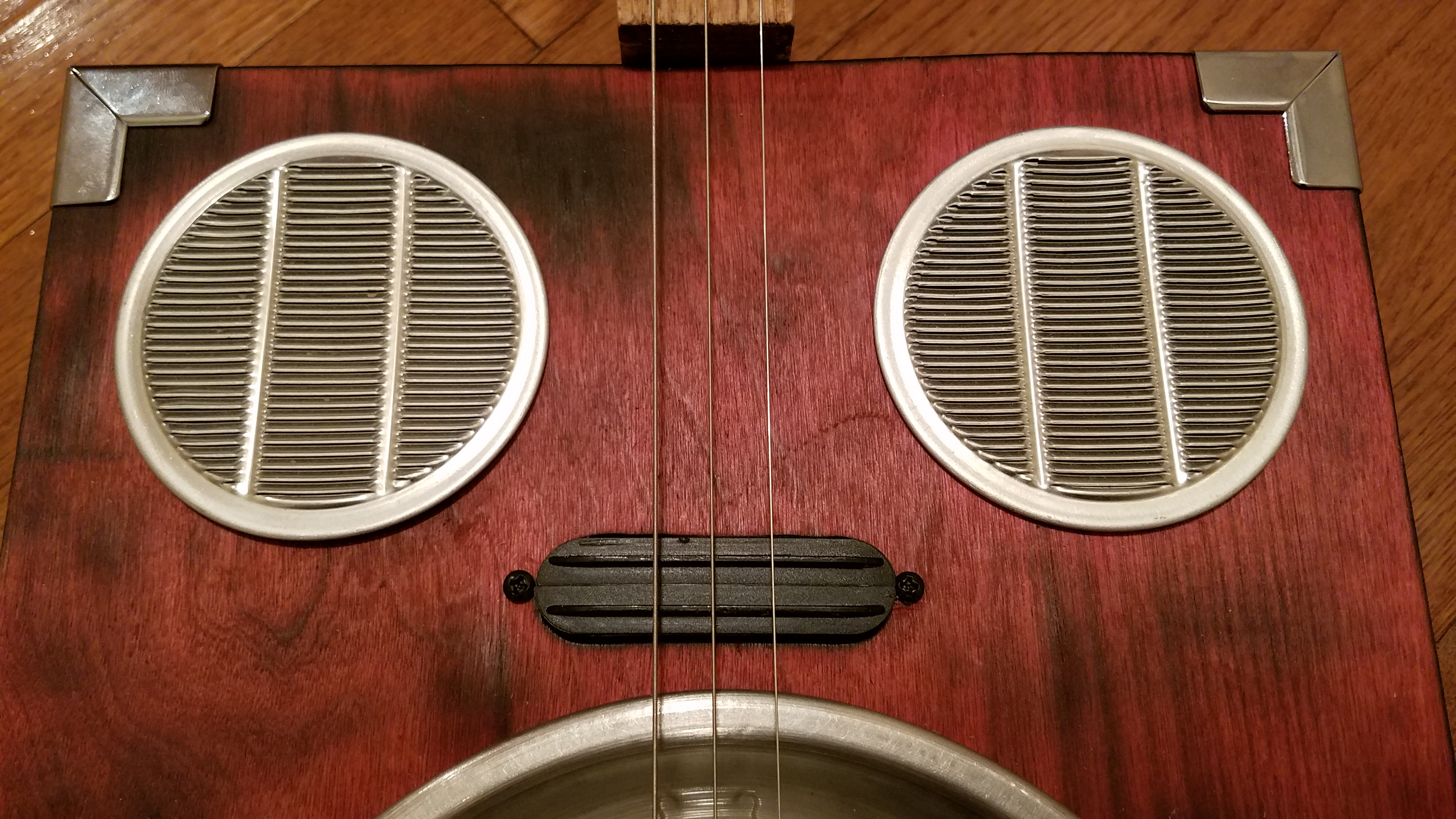 These sound hole covers are some kind of duct grillwork that I got at a tool thrift shop. Added a humbucker to play through an amp