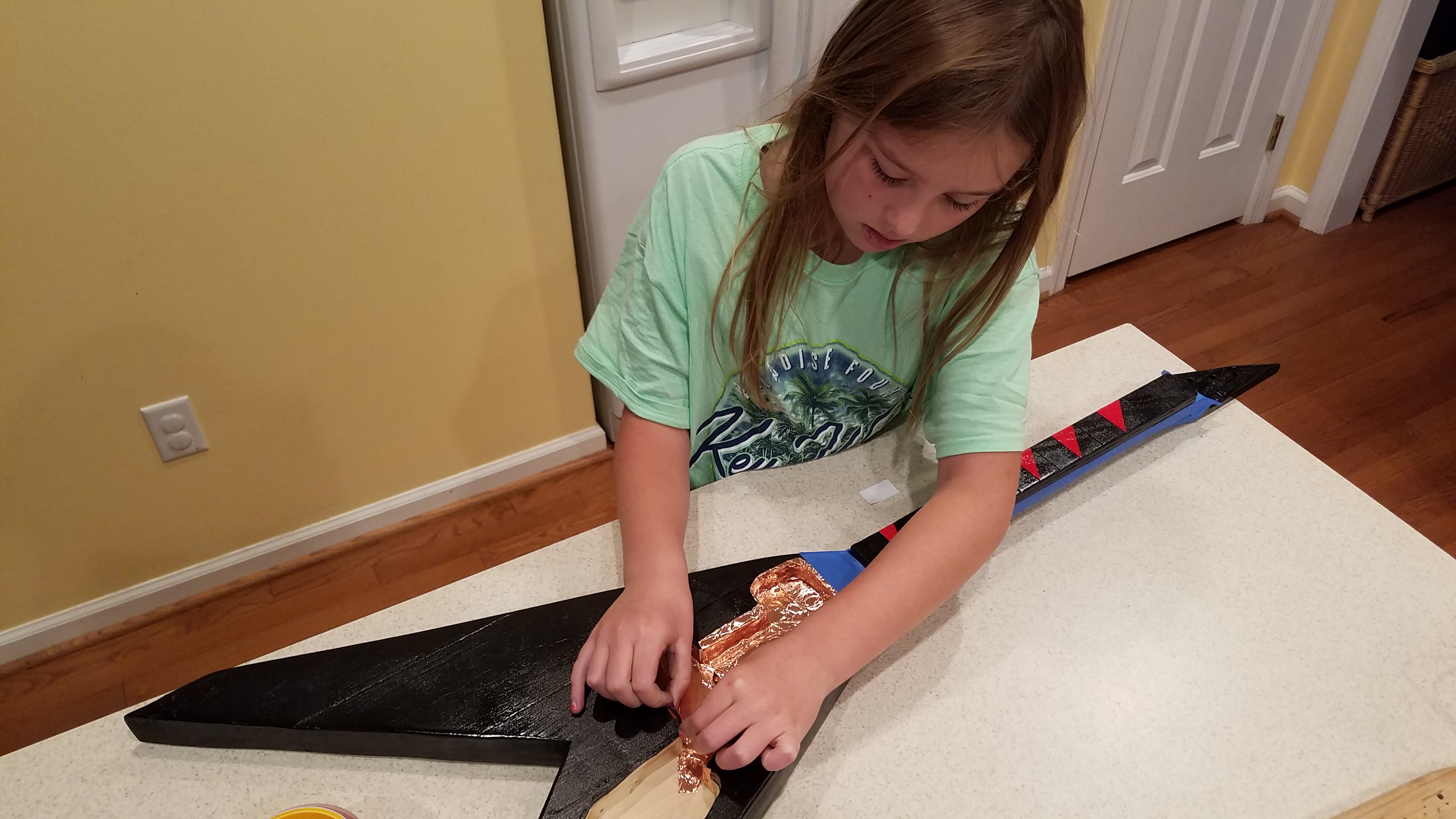 Lining the electronics cavities with copper tape to reduce hum. The tape was then grounded to the bridge.