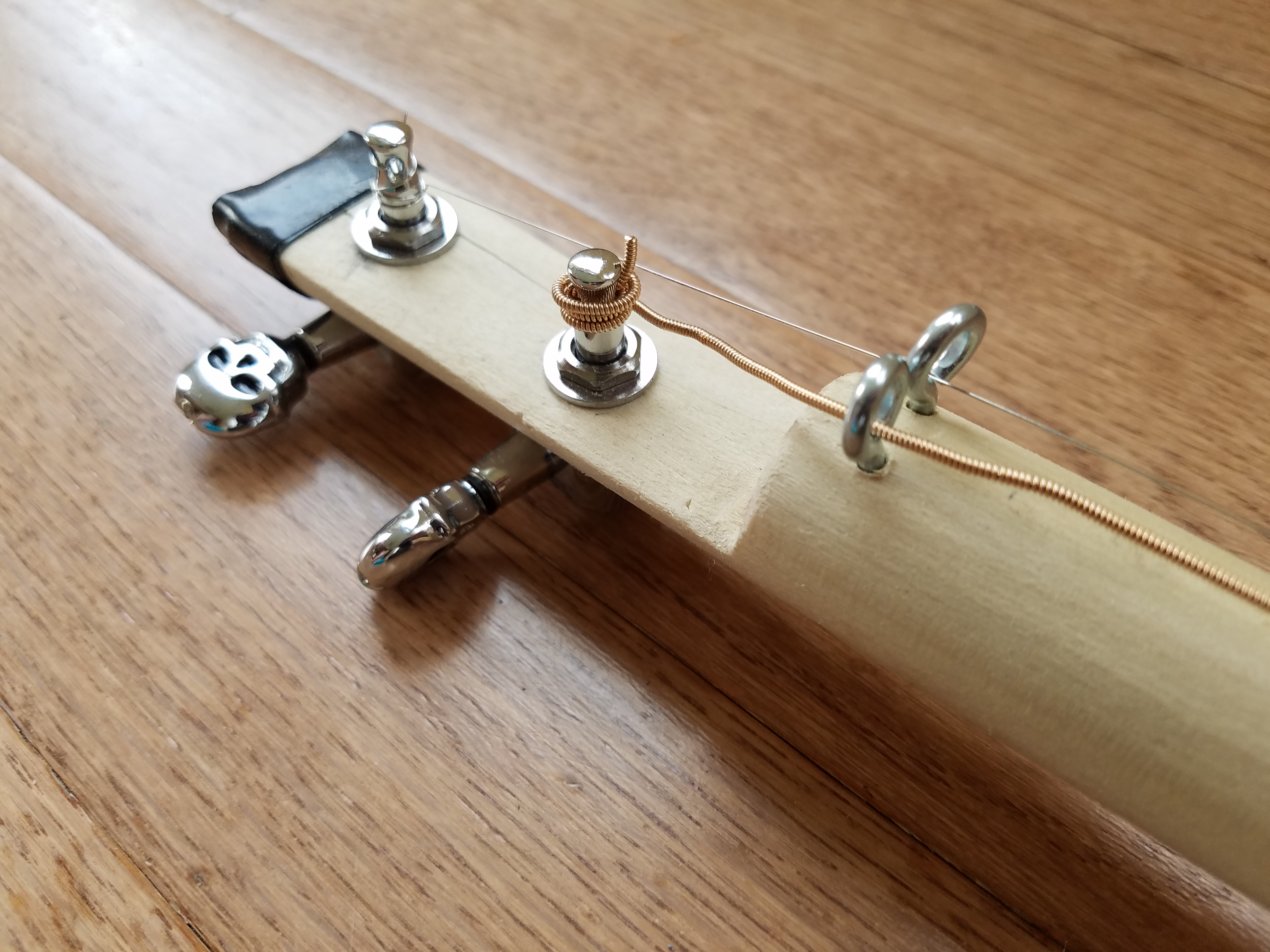 The neck split as he drilled the tuner holes…electrical tape to the rescue!