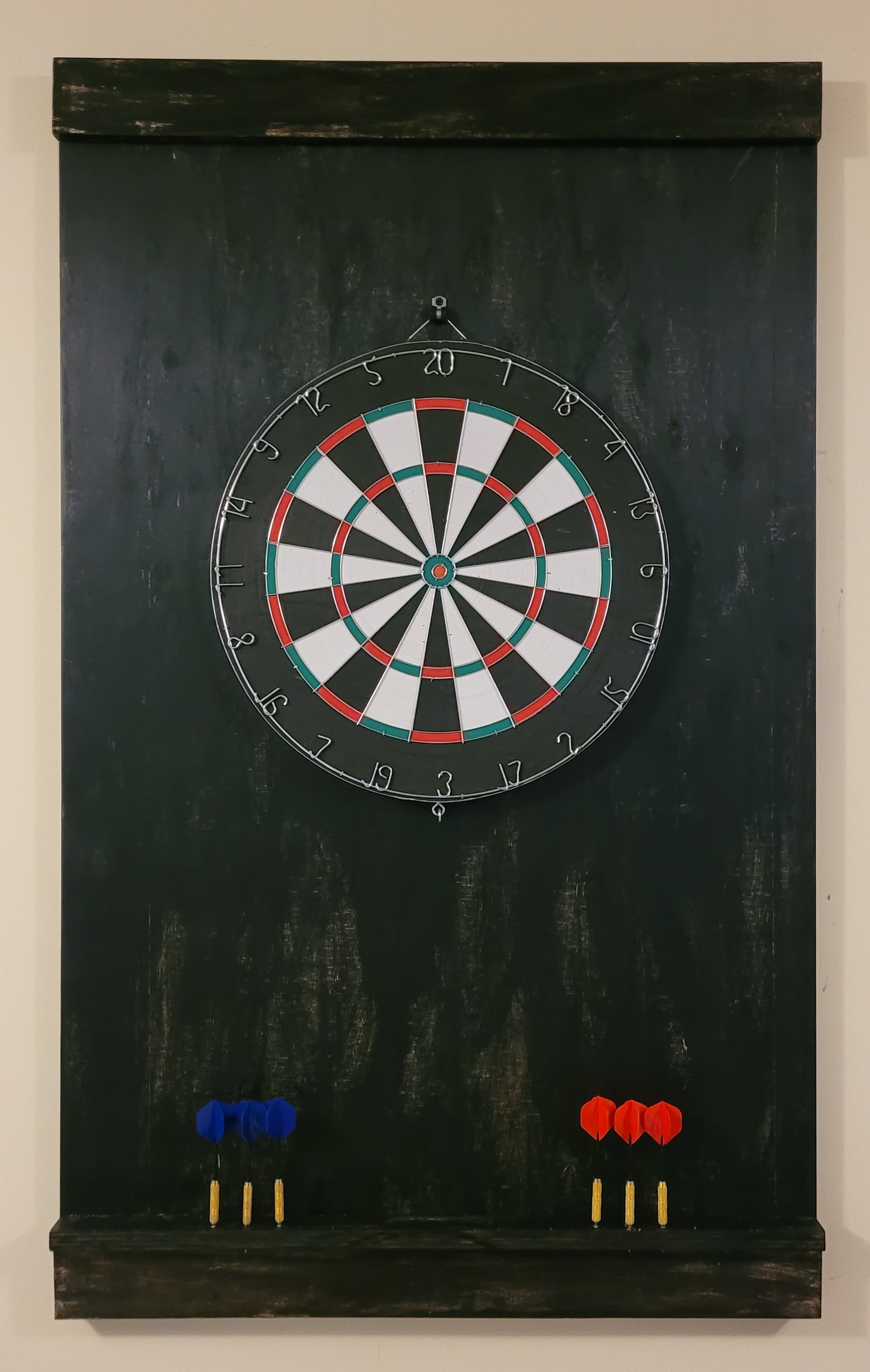 Wall protector for dart board. Added holes to store the darts